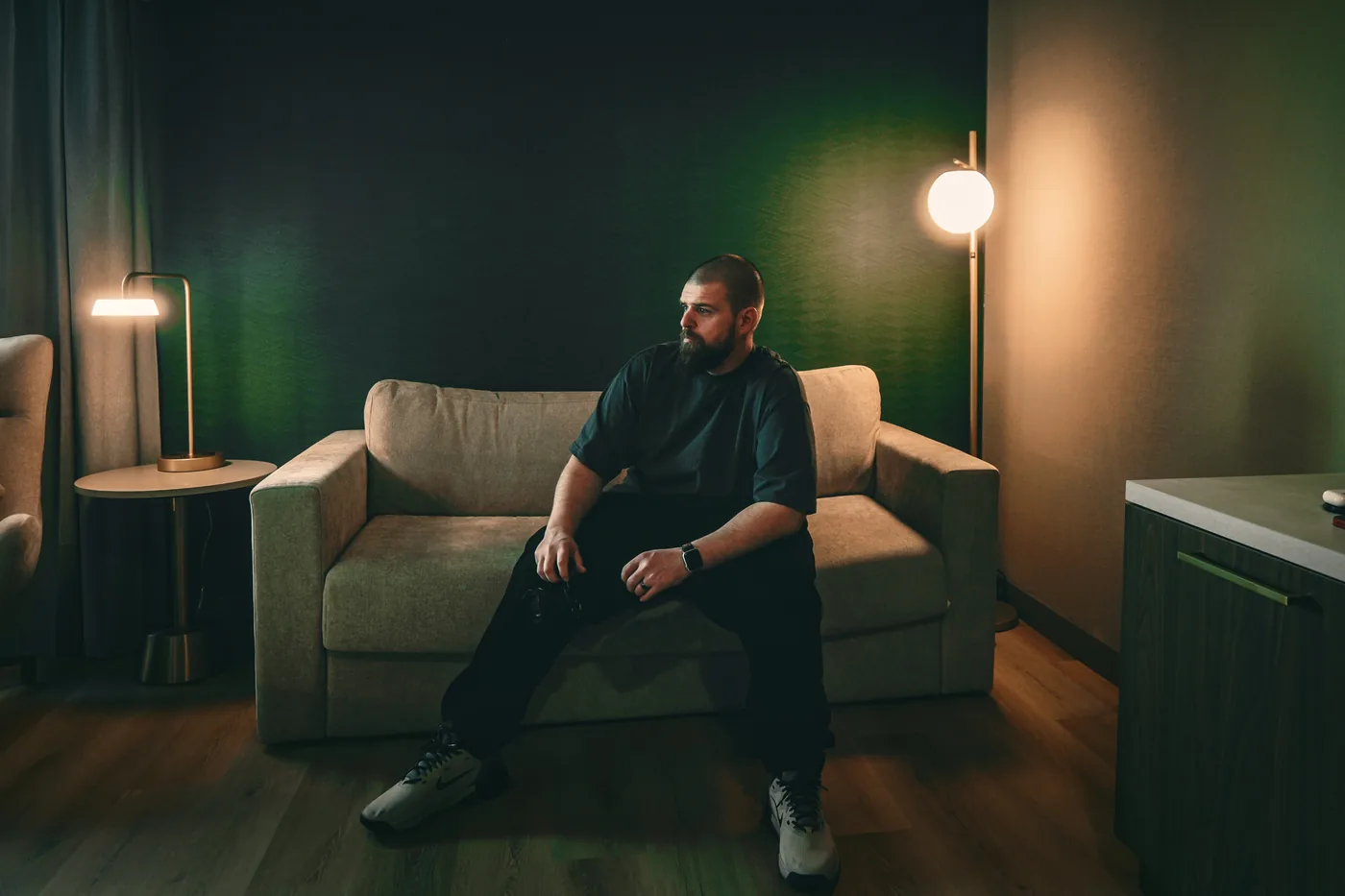 Steven 'Cheeben' Buchanan, Grants Pass filmmaker and marketing director, seated in a moody green-lit room