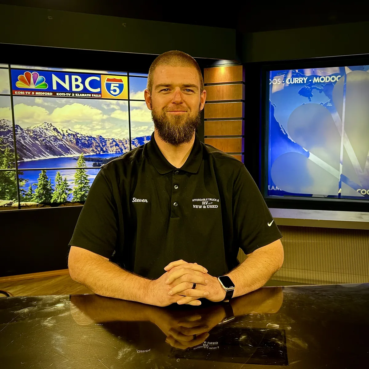 Business owner seated in a television studio